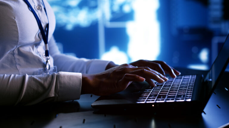 System administrator writing artificial intelligence script code in startup workspace on laptop terminal. Computer operator doing maintenance work in high tech facility updating AI systems